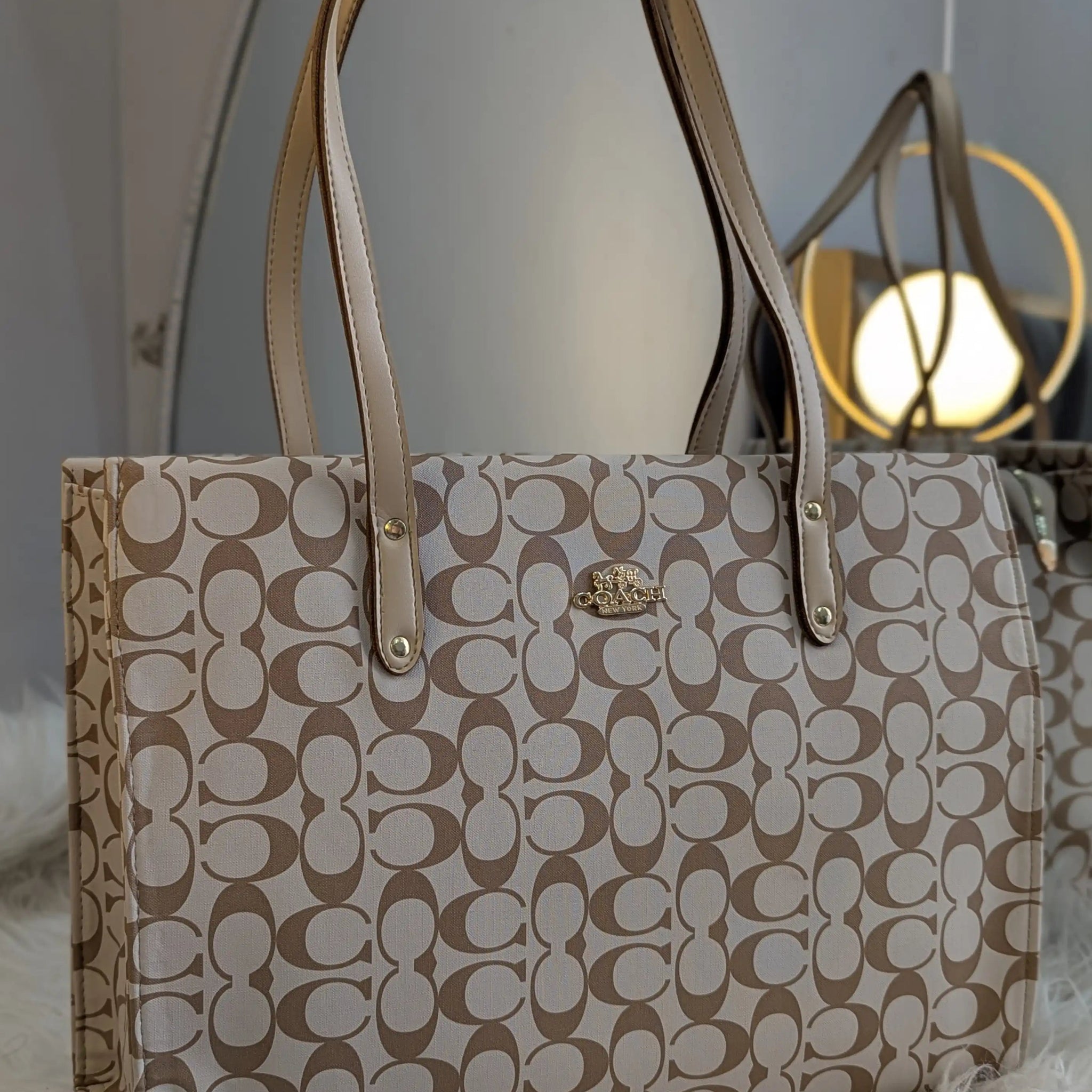 Beige handbag with a pattern on a white surface