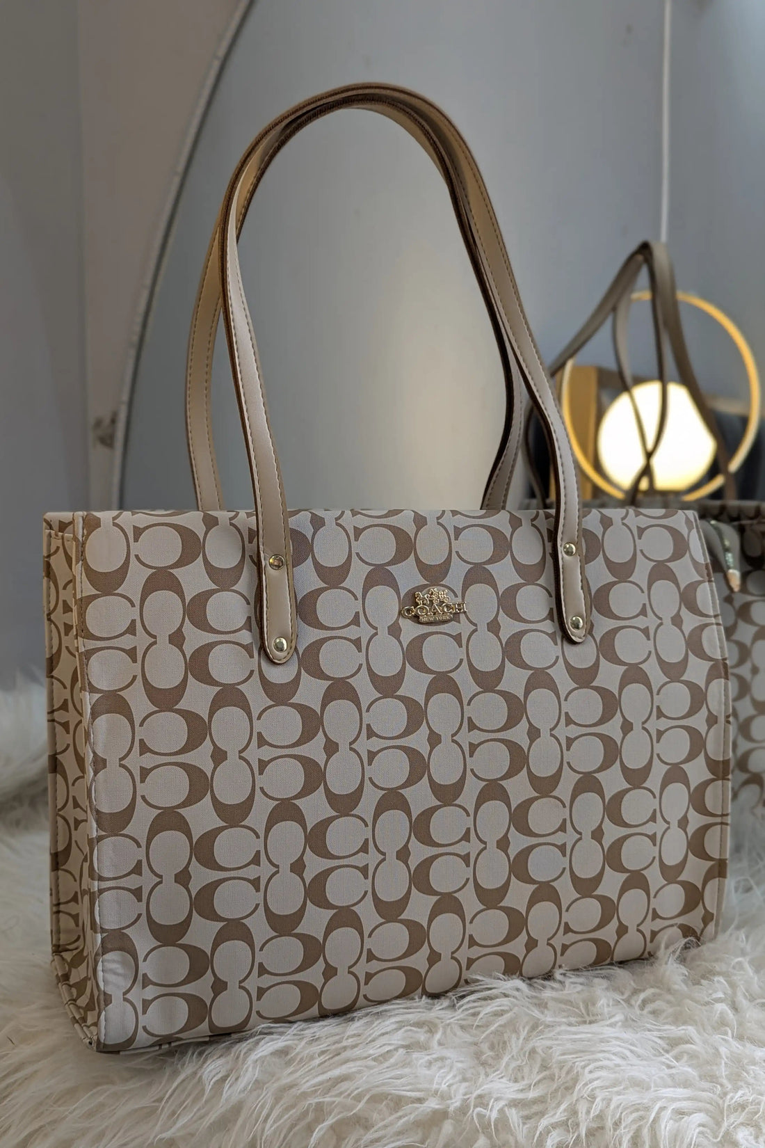 Beige handbag with a pattern on a light gray background
