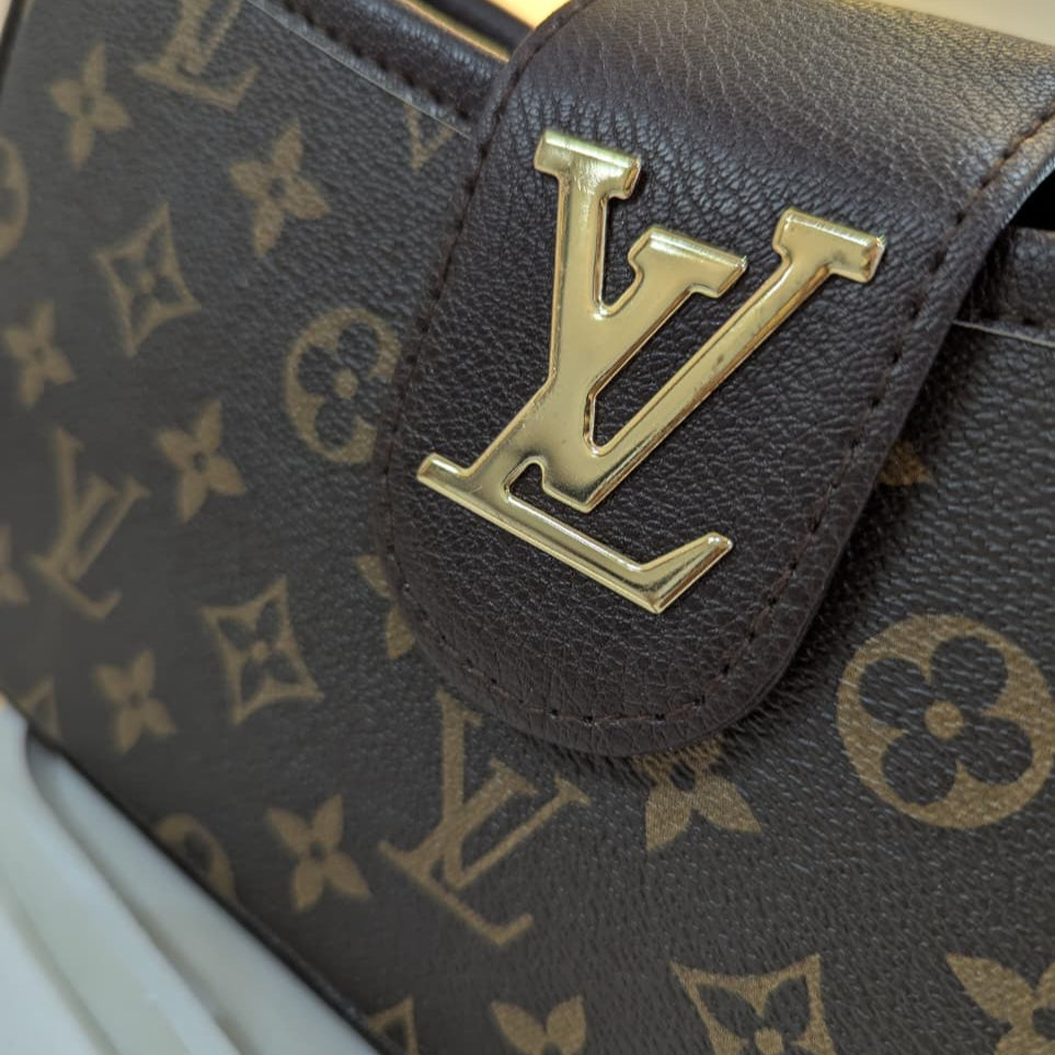 Close-up of a brown leather bag with gold logo on a white background